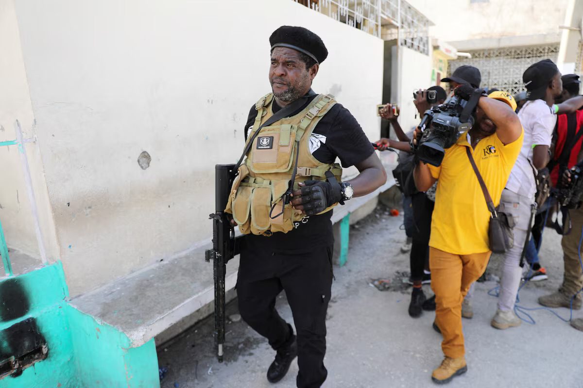 Former police officer Jimmy "Barbecue" Cherizier, and leader of an alliance of armed groups, walks past journalists, in Port-au-Prince, Haiti, March 11, 2024. REUTERS/Ralph Tedy Erol/File Photo